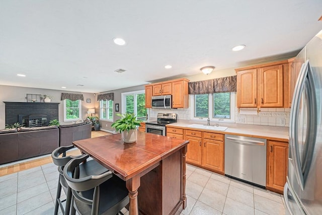 9 Captains Way E, Bridgewater, MA 02333 - kitchen featuring stainless steel appliances, healthy amount of natural light, light countertops, decorative backsplash, and recessed lighting