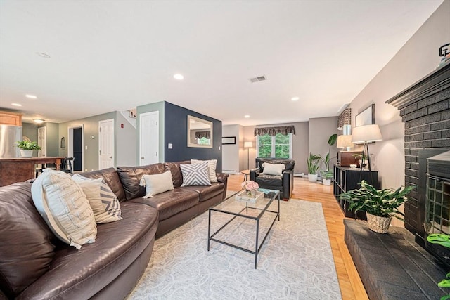 9 Captains Way E, Bridgewater, MA 02333 - living area with a brick fireplace, light wood-style flooring, recessed lighting, and baseboard heating