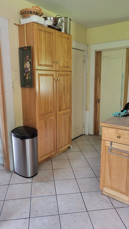 kitchen with light tile patterned flooring