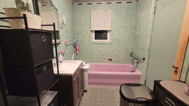 full bathroom featuring toilet, bathing tub / shower combination, tile walls, and vanity