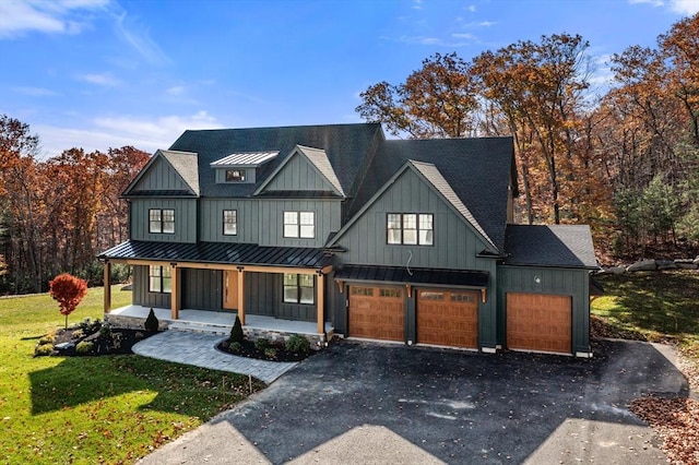 modern farmhouse style home featuring a garage, covered porch, and a front yard