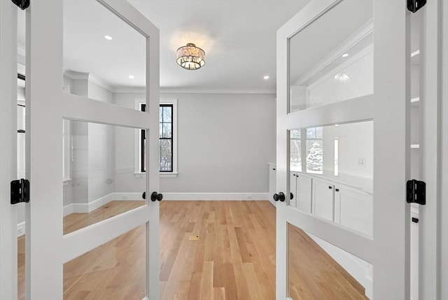 entryway featuring crown molding and light hardwood / wood-style floors