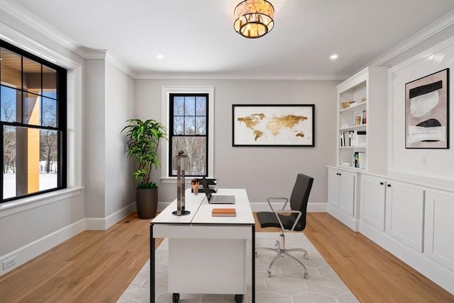 home office with light hardwood / wood-style flooring, plenty of natural light, and crown molding