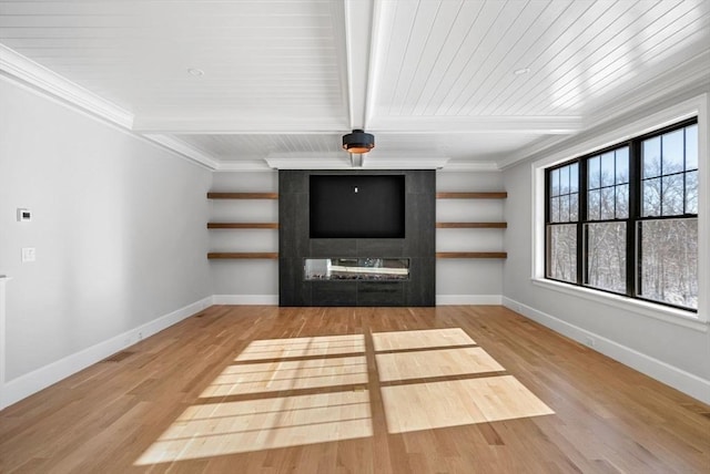 unfurnished living room with crown molding, beamed ceiling, and light wood-type flooring