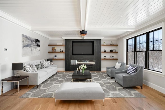 living room featuring beam ceiling, light hardwood / wood-style flooring, and crown molding