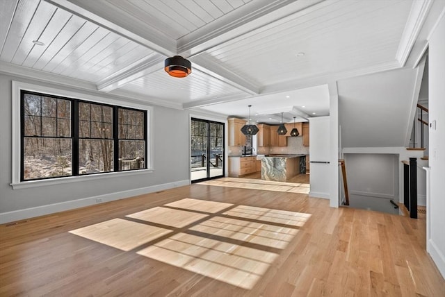 unfurnished living room with light hardwood / wood-style floors, crown molding, and beamed ceiling