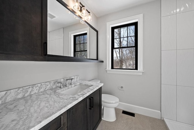 bathroom with toilet, tile patterned flooring, and vanity