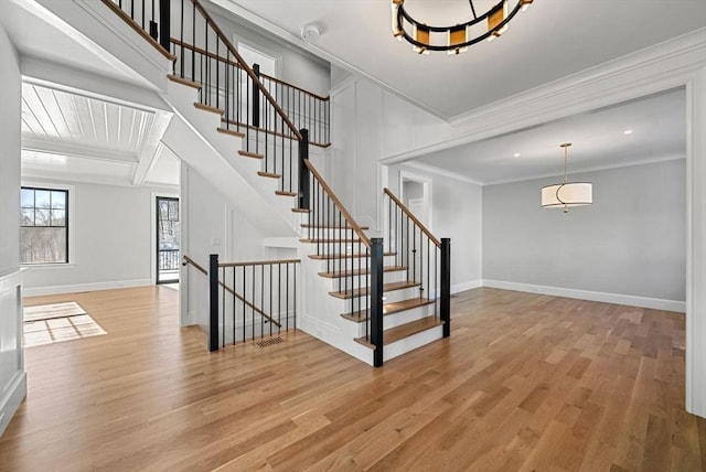 staircase featuring hardwood / wood-style flooring and ornamental molding