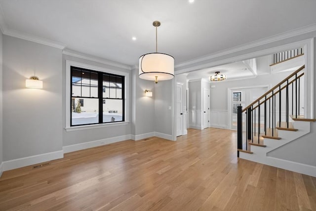 entryway featuring light wood-type flooring and ornamental molding