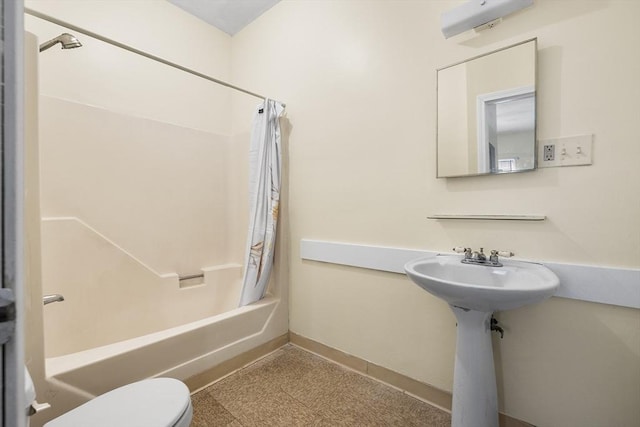 bathroom with toilet and shower / tub combo