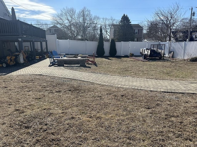 view of yard featuring an outdoor fire pit, a fenced backyard, and a patio