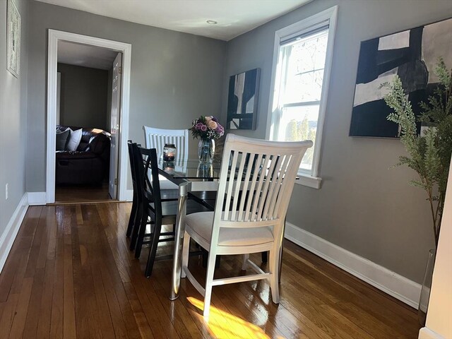 dining area with hardwood / wood-style flooring and baseboards