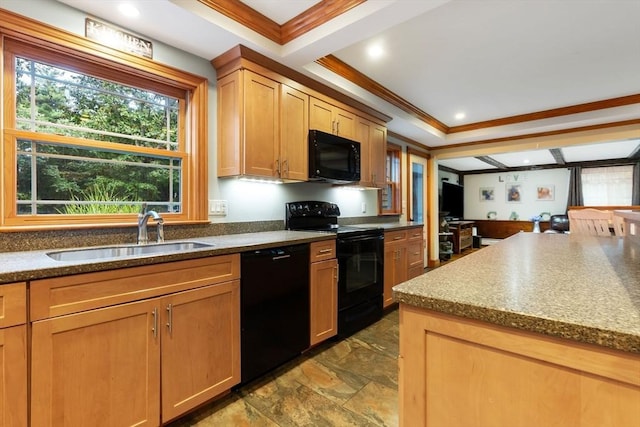 kitchen featuring crown molding, a sink, stone finish flooring, and black appliances