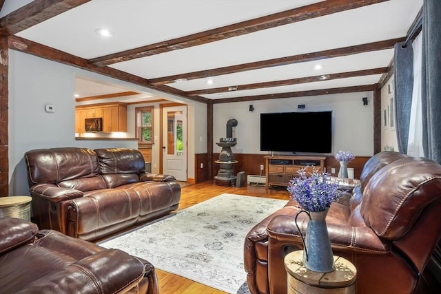 living room with light wood-type flooring, a baseboard radiator, beam ceiling, and recessed lighting
