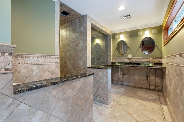 bathroom with visible vents, a walk in shower, tile patterned floors, and tile walls