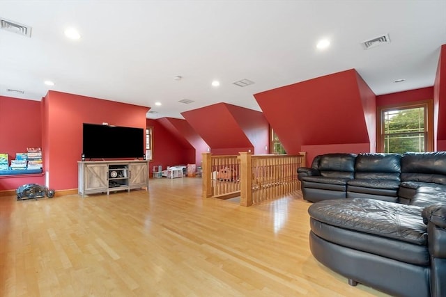 living area featuring recessed lighting, visible vents, and wood finished floors
