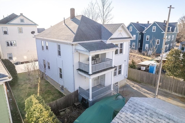 back of property with a balcony