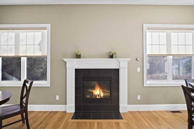 25 Salisbury Hill Blvd Unit 62, Worcester, MA 01609 - room details with baseboards, a tile fireplace, visible vents, and wood finished floors