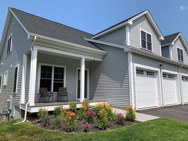 25 Salisbury Hill Blvd Unit 62, Worcester, MA 01609 - view of front of home with roof with shingles, a porch, aphalt driveway, and an attached garage
