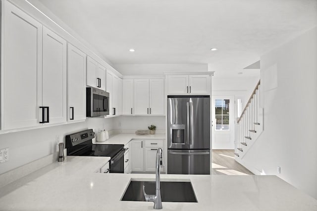 25 Salisbury Hill Blvd Unit 62, Worcester, MA 01609 - kitchen with recessed lighting, a sink, light countertops, white cabinets, and appliances with stainless steel finishes