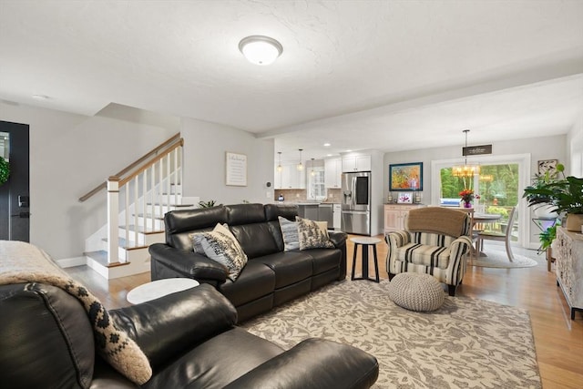 187 Run Brook Cir, Taunton, MA 02780 - living area with light wood finished floors, stairway, and a chandelier
