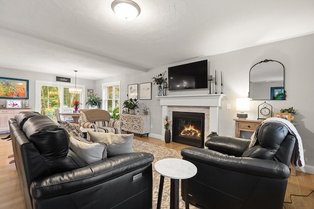187 Run Brook Cir, Taunton, MA 02780 - living room with light wood-style floors, a chandelier, and a tile fireplace