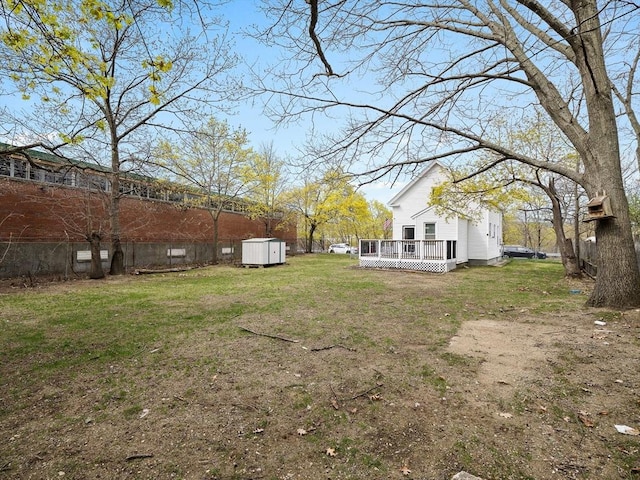 73 Laurel St, Leominster, MA 01453 - view of yard featuring fence, a wooden deck, an outbuilding, and a shed