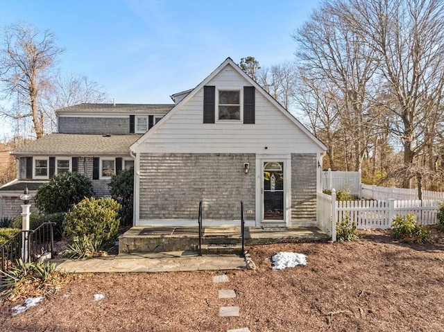 rear view of house with fence