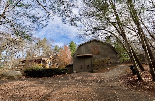 view of property exterior with an outdoor structure