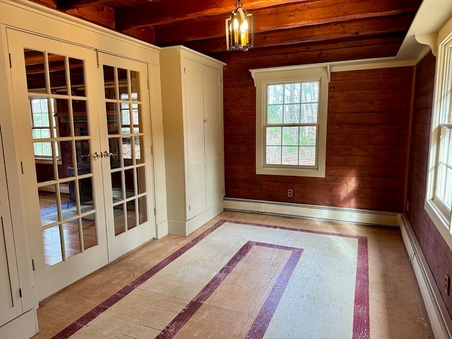 unfurnished room featuring baseboard heating and french doors