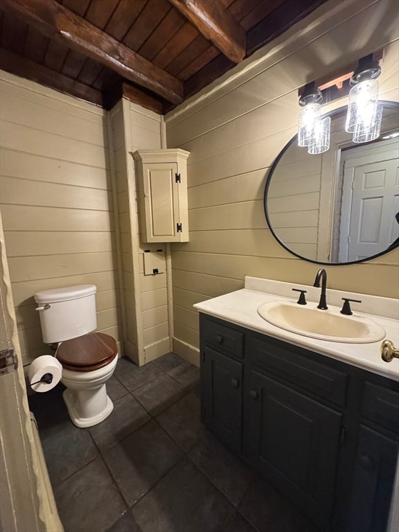 bathroom with toilet, wood ceiling, wooden walls, tile patterned floors, and beam ceiling