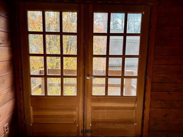 entryway with wooden walls