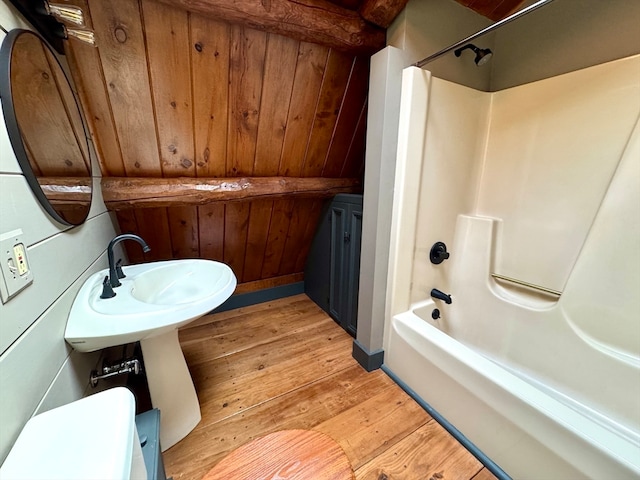 bathroom with washtub / shower combination, wood ceiling, and hardwood / wood-style flooring