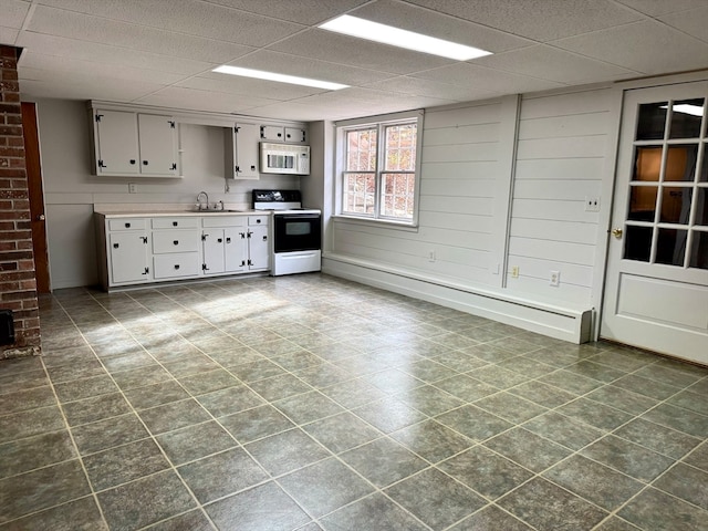 kitchen with white cabinetry, sink, and white appliances