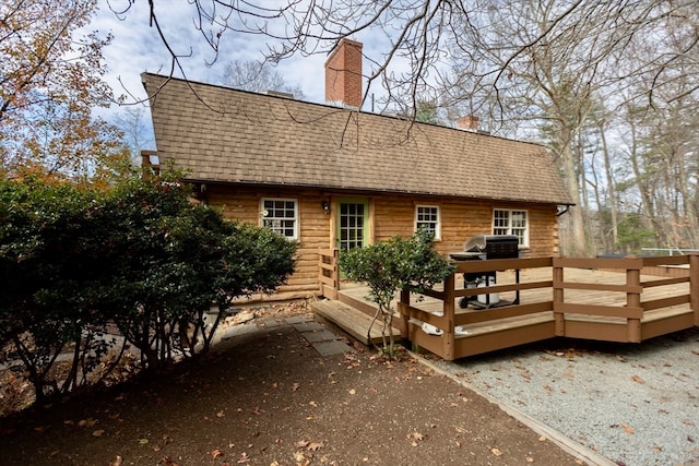 back of house featuring a wooden deck