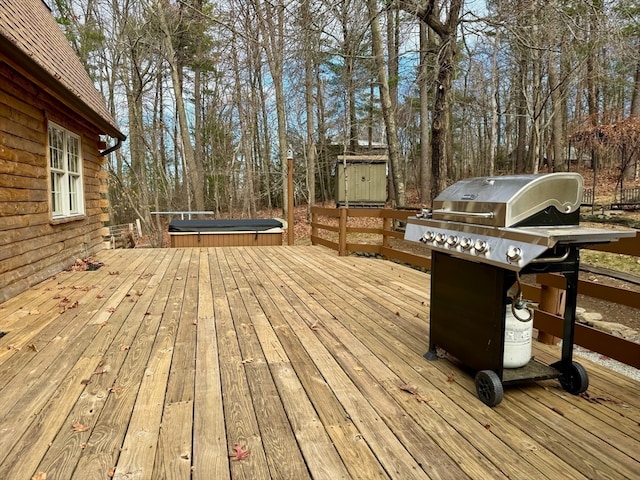 wooden terrace with grilling area and a trampoline