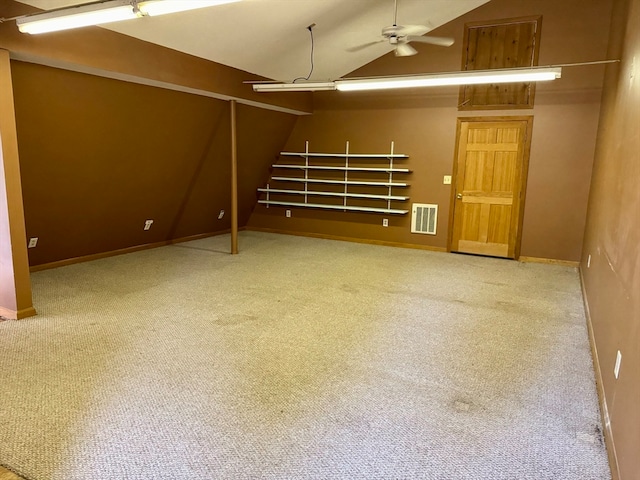 basement with ceiling fan and carpet flooring