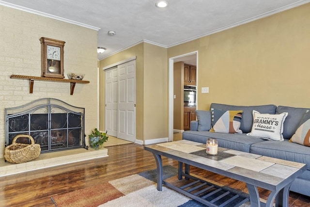 living room featuring a fireplace, ornamental molding, and dark hardwood / wood-style floors