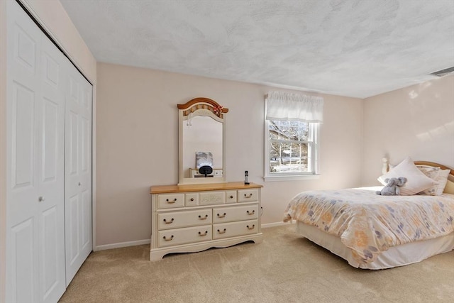 carpeted bedroom featuring a closet