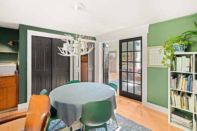 dining room with a chandelier and light wood finished floors