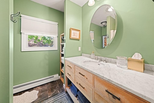 bathroom with a baseboard radiator, marble finish floors, and vanity