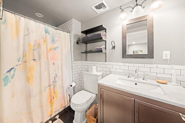 bathroom with tile walls, toilet, vanity, and a shower with shower curtain