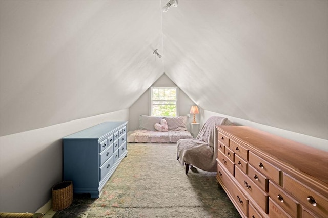 carpeted bedroom with lofted ceiling