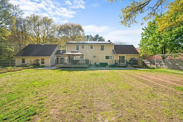 rear view of property with a gazebo and a wooden deck