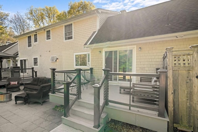 back of property featuring an outdoor hangout area, a wooden deck, roof with shingles, and a gazebo