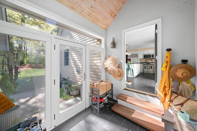 doorway to outside featuring lofted ceiling, wood ceiling, and healthy amount of natural light