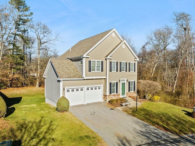 view of front of property featuring a front yard and a garage