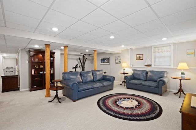 carpeted living room with a drop ceiling