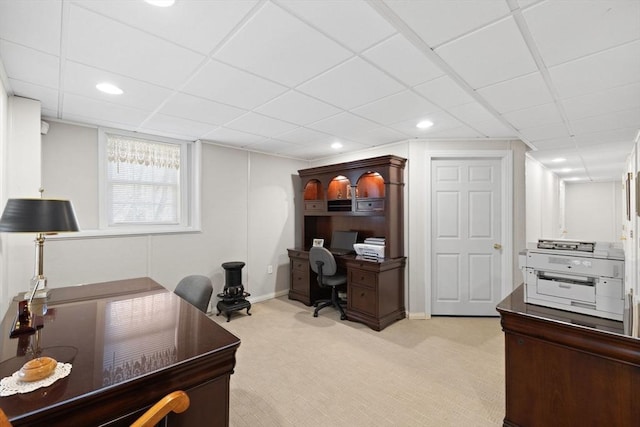 home office featuring light carpet and a paneled ceiling