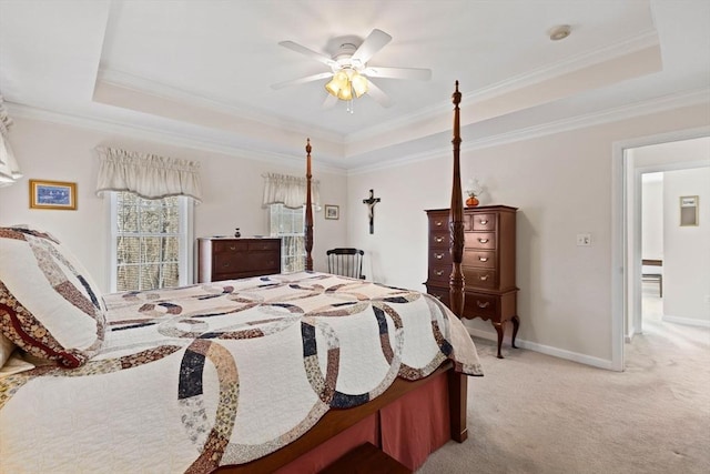 carpeted bedroom featuring ceiling fan, a raised ceiling, and crown molding